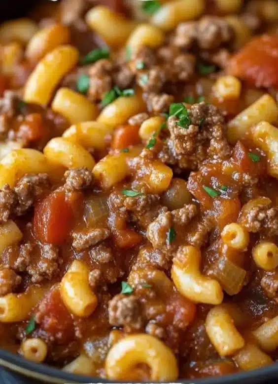 Delicious Ground Beef Goulash topped with cheese in a bowl, ideal for family dinners.