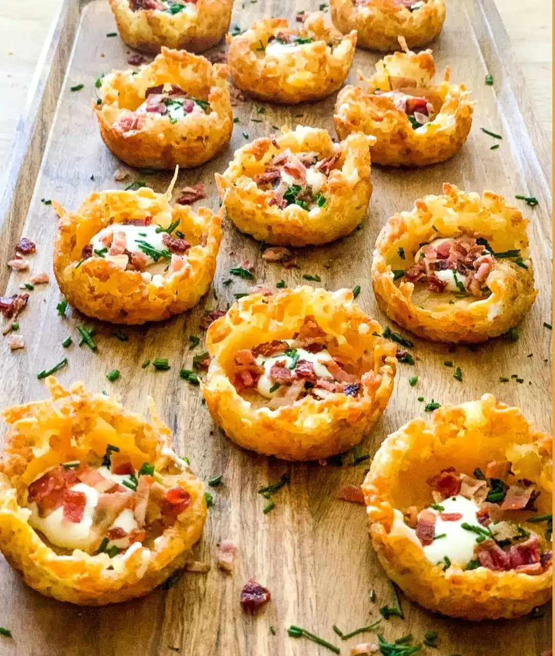 Loaded tater tot appetizers garnished with cheese and toppings