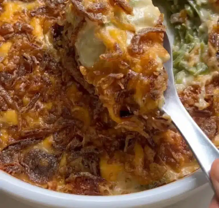 Delicious green bean casserole topped with crispy onions and served in a baking dish.