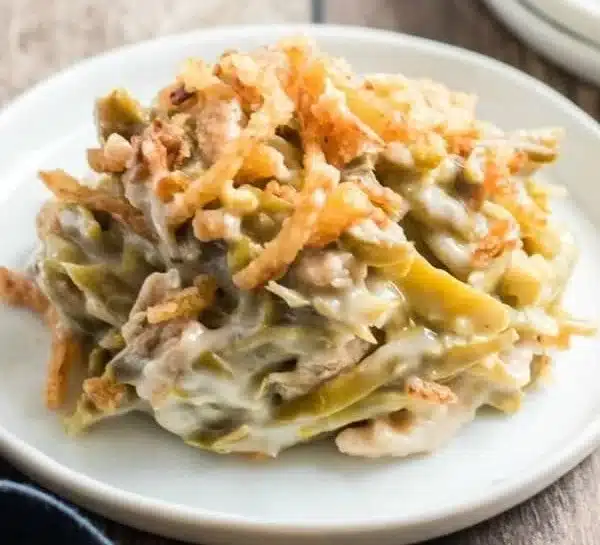 Delicious green bean casserole served in a baking dish topped with crispy onions.