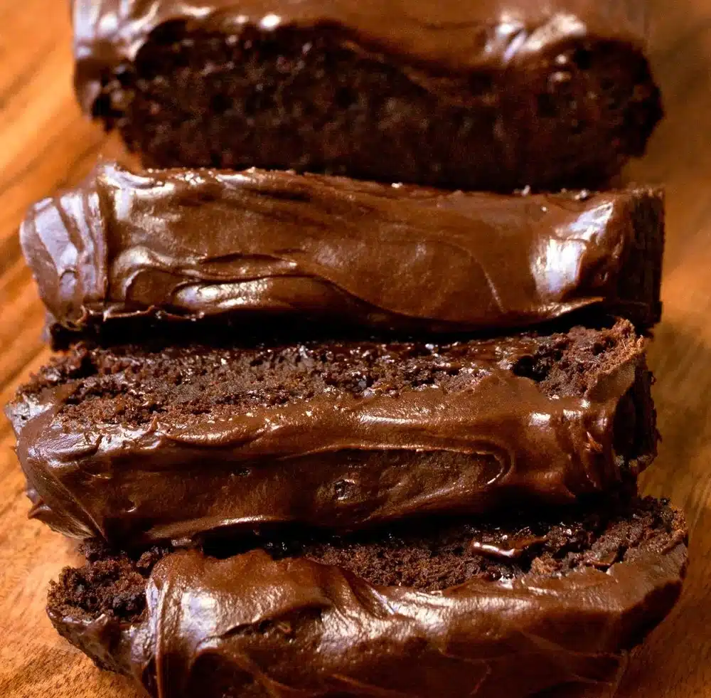 Dark Chocolate Pumpkin Bread with Frosting on a wooden table