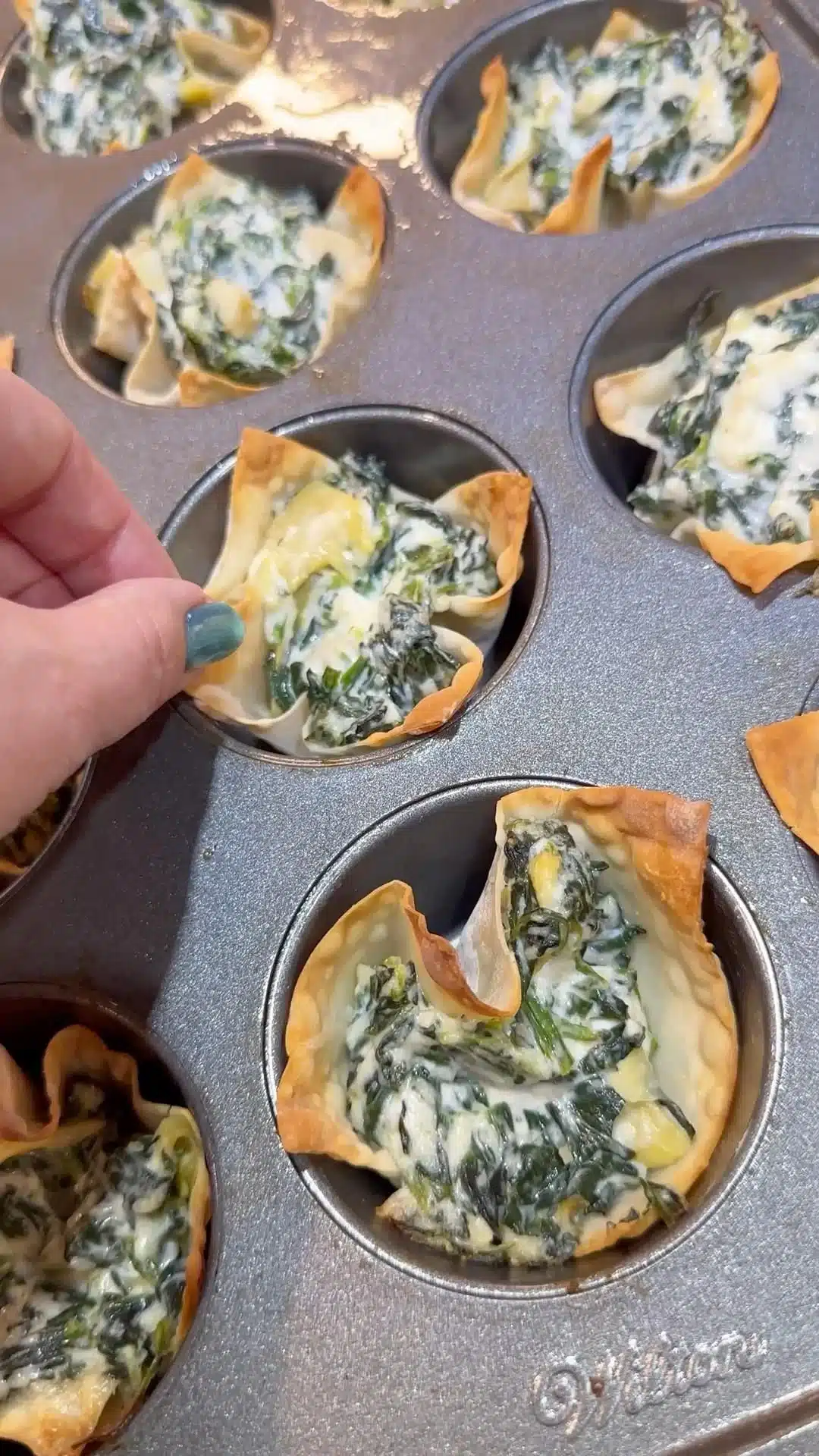 Delicious spinach artichoke wonton cups served as a tasty appetizer.