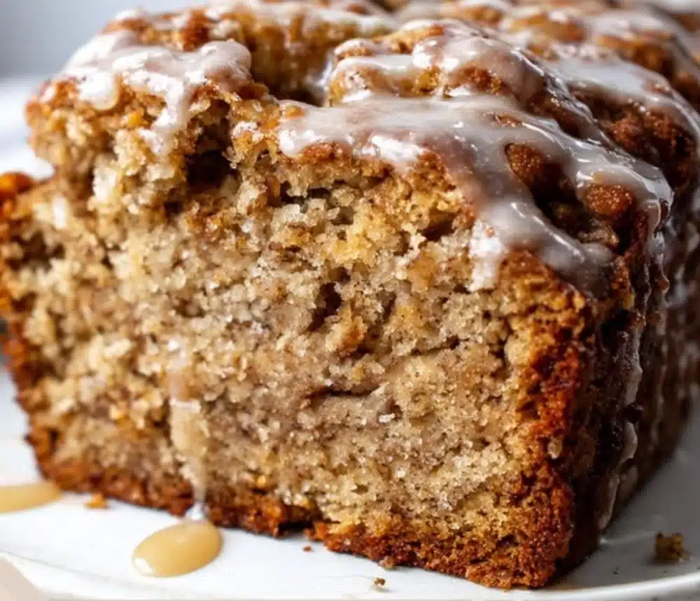 Moist pumpkin banana bread fresh out of the oven, topped with walnuts.