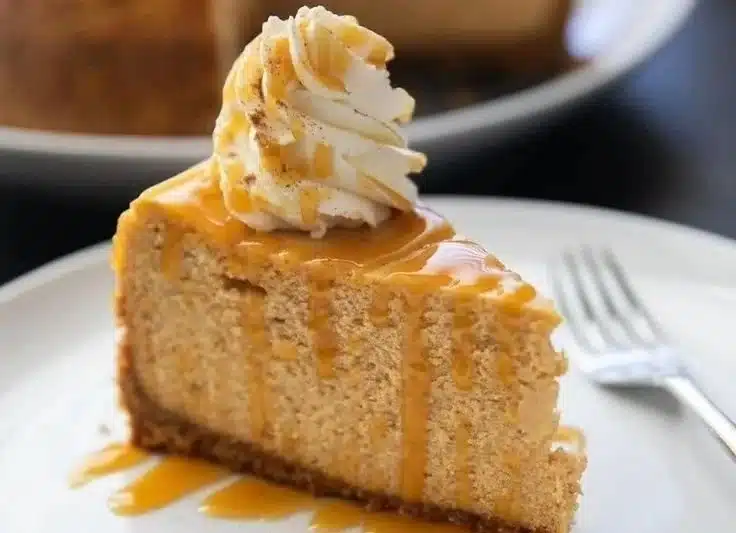 Delicious homemade pumpkin cheesecake topped with whipped cream
