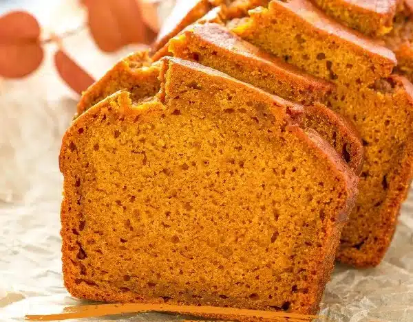 Slice of homemade Starbucks copycat pumpkin bread on a wooden table